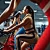 woman-drinks-water-on-a-stationary-bike-in-gym-5YEDLJY-min.jpg